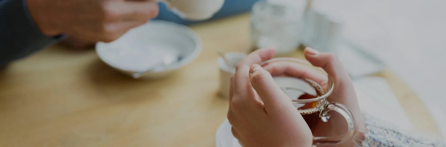 woman holding a cup of hot tea